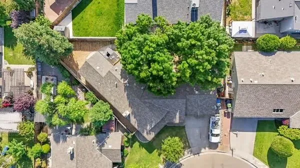 an aerial view of a house with a yard and potted plants