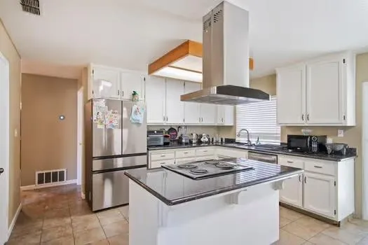 a kitchen with a stove a refrigerator and a sink