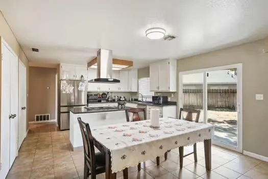 a kitchen with a table and chairs in it
