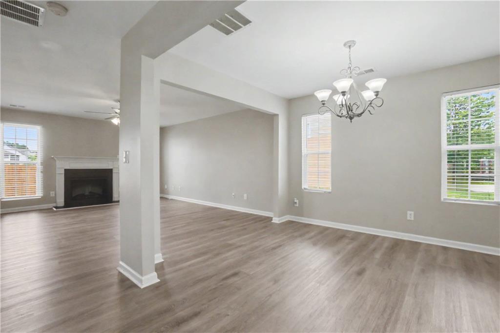 375 Walton View Fairburn, GA 30213 - Photo 7 of 38 a view of a livingroom with a fireplace wooden floor and chandelier
