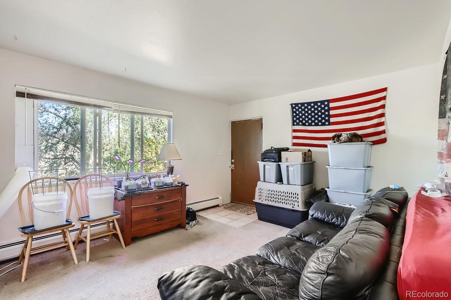 6190 Webster Street Arvada, CO 80003 - Photo 3 of 11 a bedroom with furniture and a window