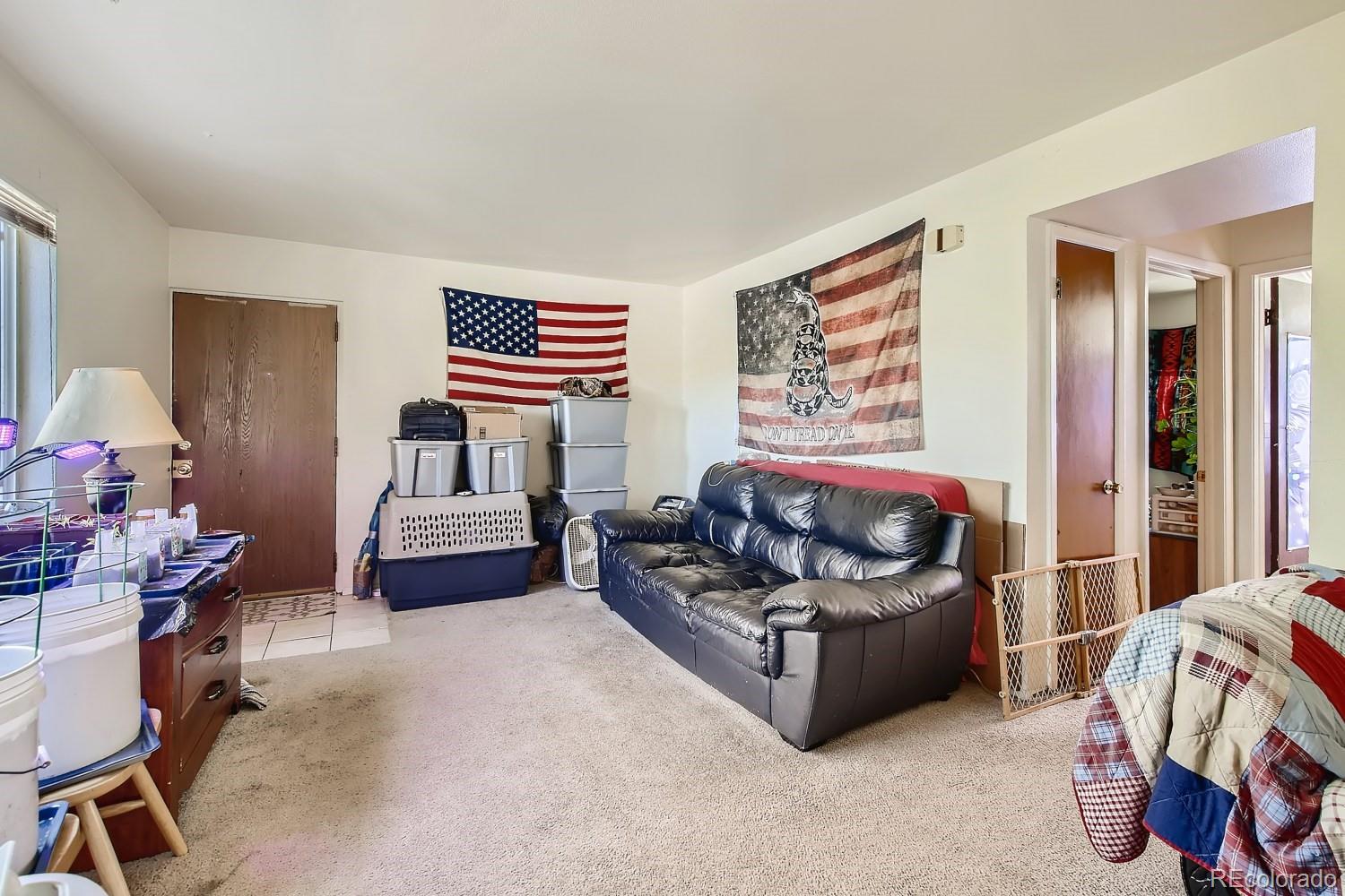 6190 Webster Street Arvada, CO 80003 - Photo 4 of 11 a bedroom with furniture and a window