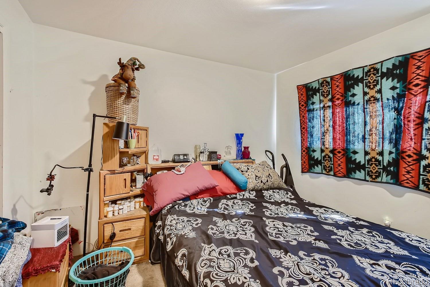 6190 Webster Street Arvada, CO 80003 - Photo 8 of 11 a bedroom with a bed and a window