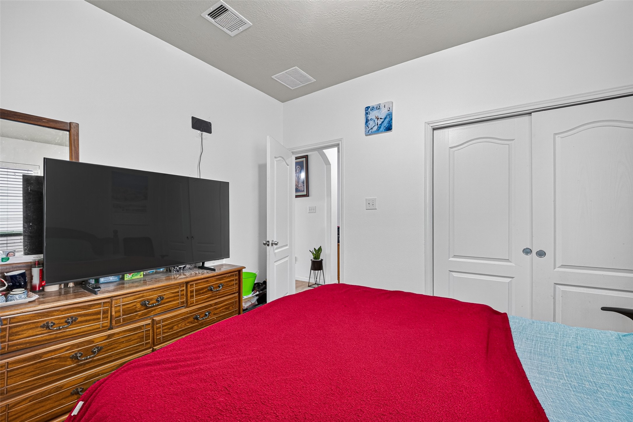 9314 Fuqua Ridge Lane Houston, TX 77075 - Photo 14 of 24 a bedroom with a bed and a flat screen tv