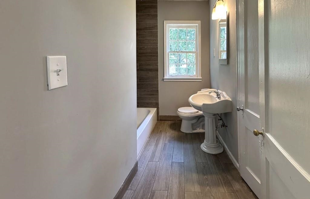 3400 Hadley Road Memphis, TN 38111 - Photo 3 of 8 Bathroom with wood-type flooring, toilet, and sink