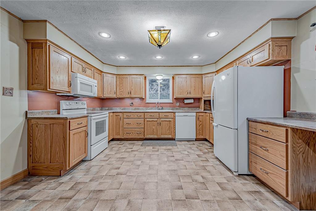 549 Filmore Road Pittsburgh, PA 15221 - Photo 8 of 25 a kitchen with a refrigerator sink and cabinets
