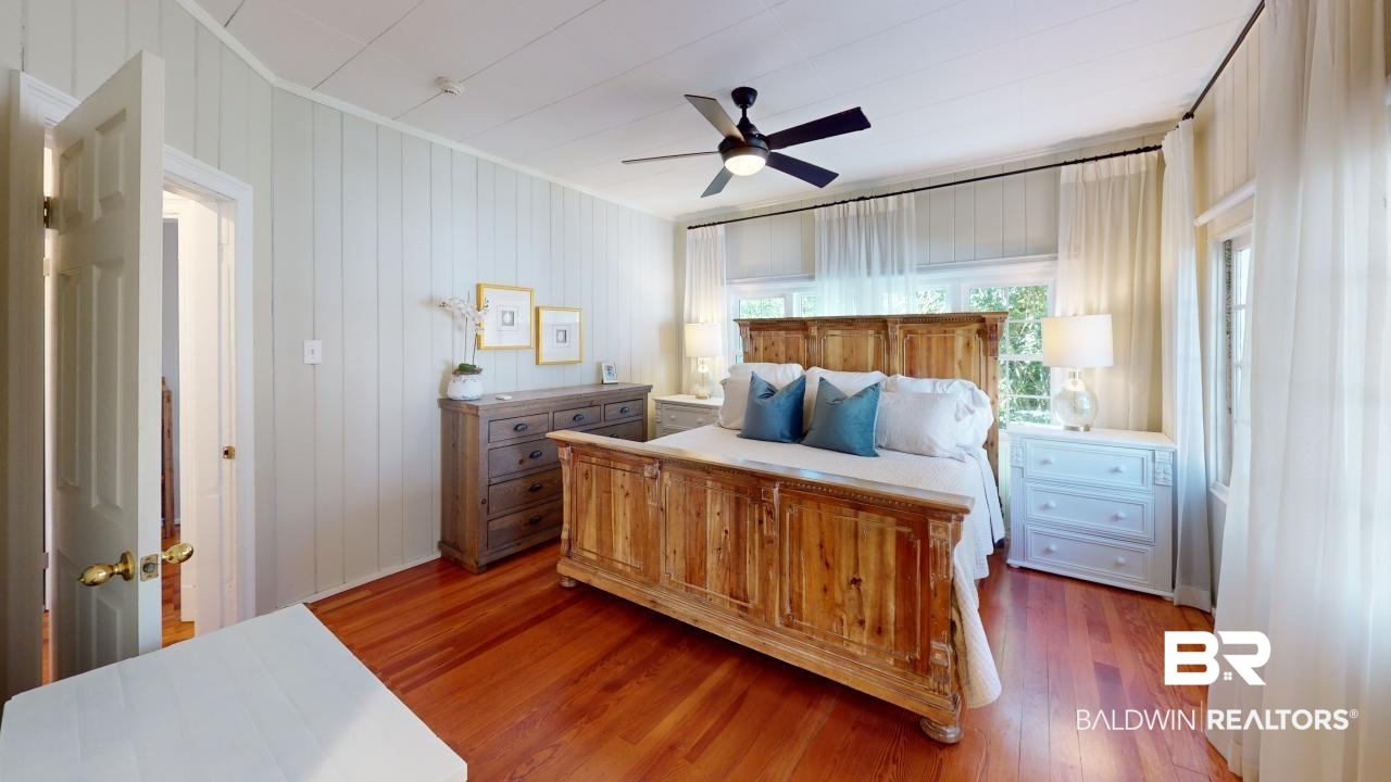 4358 Stein Street Mobile, AL 36608 - Photo 12 of 29 Bedroom with dark hardwood / wood-style flooring, ceiling fan, and wood walls
