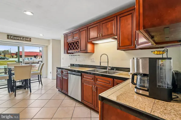 a kitchen with stainless steel appliances granite countertop a sink and cabinets