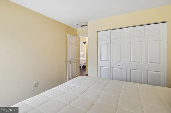 a view of a bedroom with wooden floor