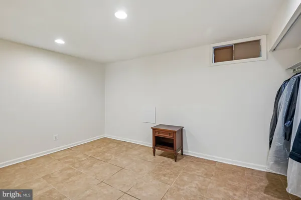 a view of walk in closet with clothes