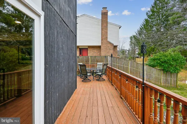 a view of balcony with wooden floor and fence