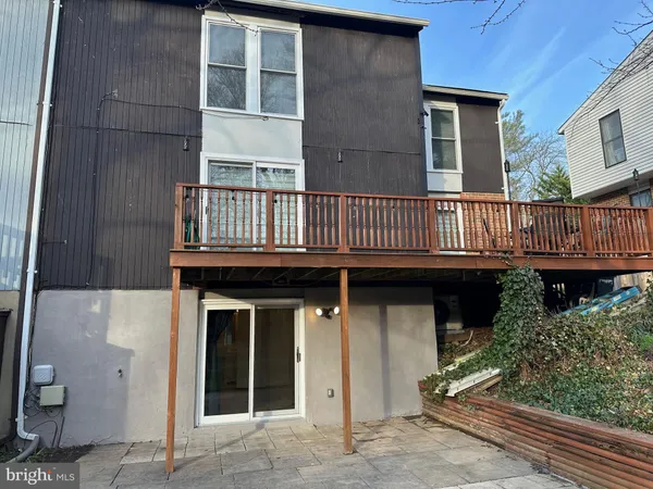 a view of a house with a wooden deck