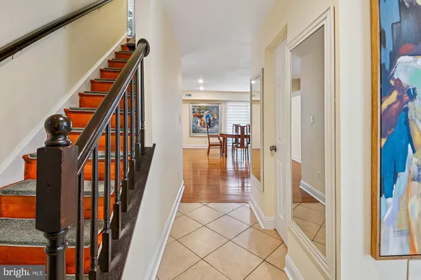a view of an entryway with wooden floor and stairs