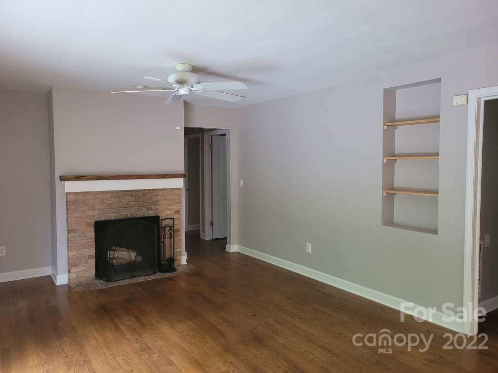 706 Fieldstone Road Mooresville, NC 28115 - Photo 5 of 11 a view of an empty room with wooden floor fireplace and a window