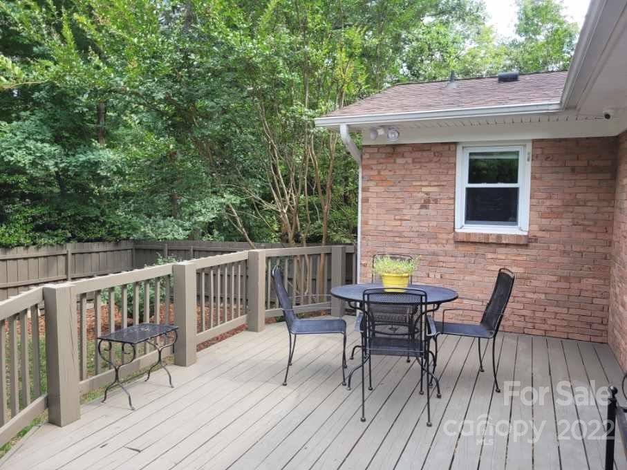 706 Fieldstone Road Mooresville, NC 28115 - Photo 6 of 11 a view of deck with table and chairs and wooden floor