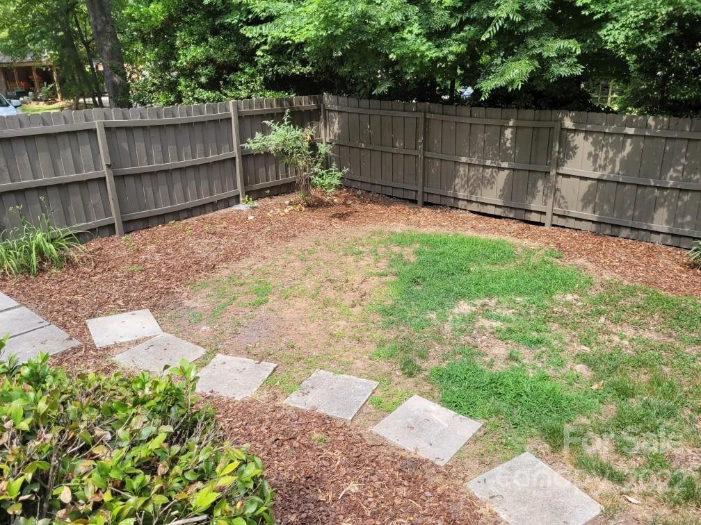 706 Fieldstone Road Mooresville, NC 28115 - Photo 7 of 11 a view of a backyard with a wooden fence
