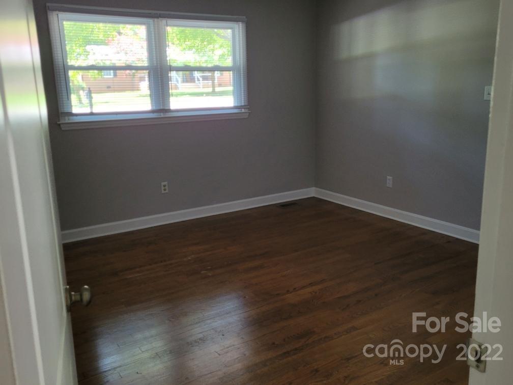 706 Fieldstone Road Mooresville, NC 28115 - Photo 9 of 11 an empty room with wooden floor and windows
