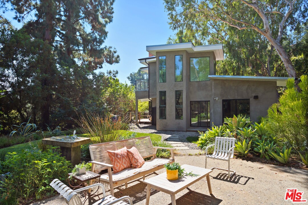 9015 Burroughs Road Los Angeles, CA 90046 - Photo 1 of 19 a view of a patio with couches table and chairs and potted plants