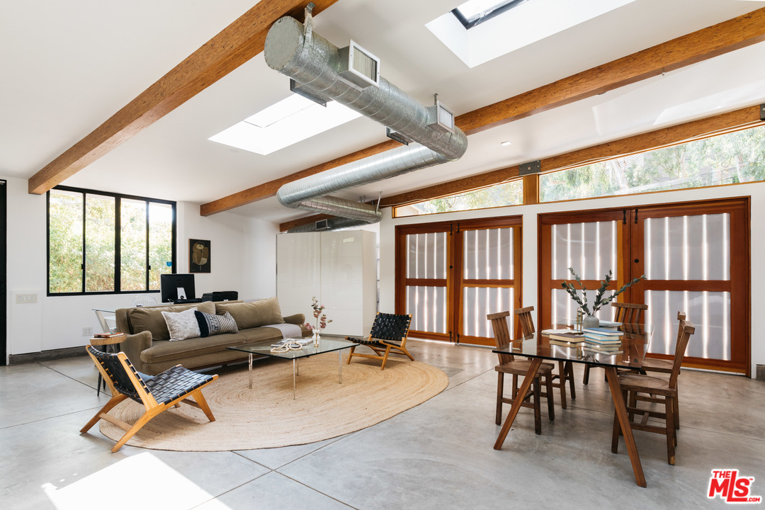 9015 Burroughs Road Los Angeles, CA 90046 - Photo 18 of 19 a living room with furniture a floor to ceiling windows and floor to ceiling windows