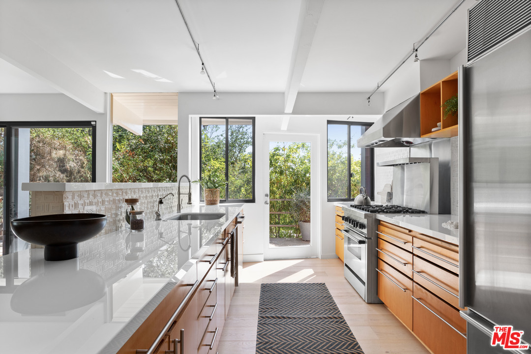 9015 Burroughs Road Los Angeles, CA 90046 - Photo 3 of 19 a living room with large window and stainless steel appliances