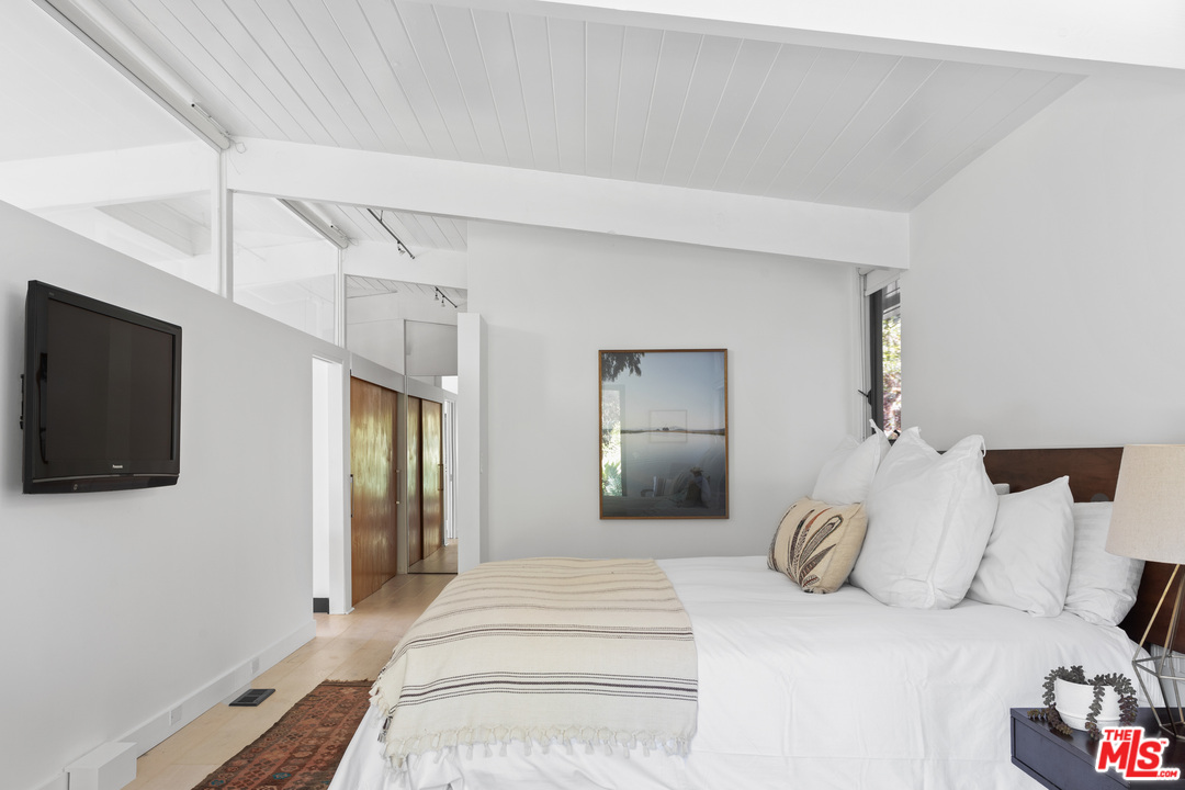 9015 Burroughs Road Los Angeles, CA 90046 - Photo 5 of 19 a bedroom with a bed and a flat screen tv
