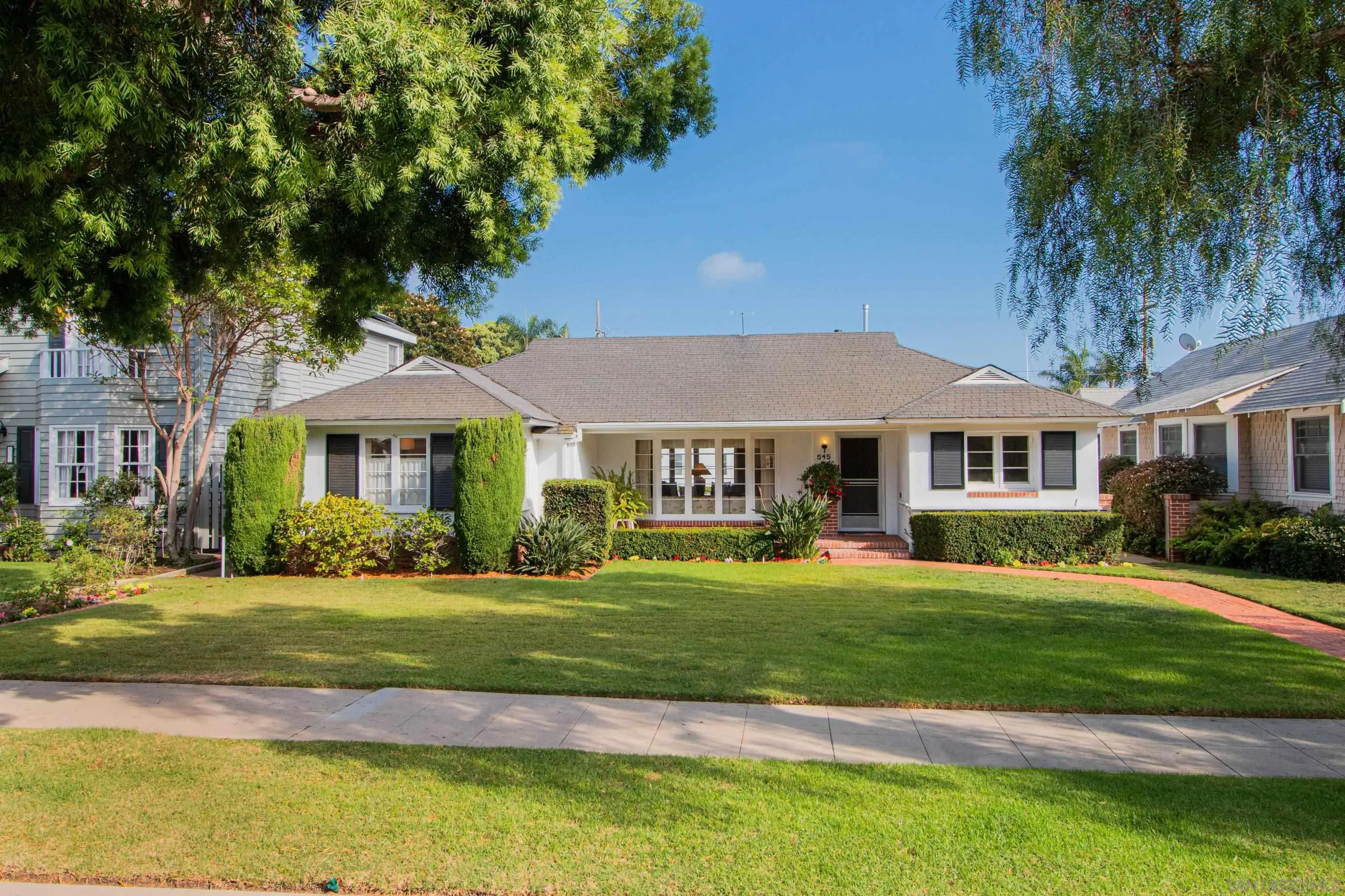 a front view of a house with a garden