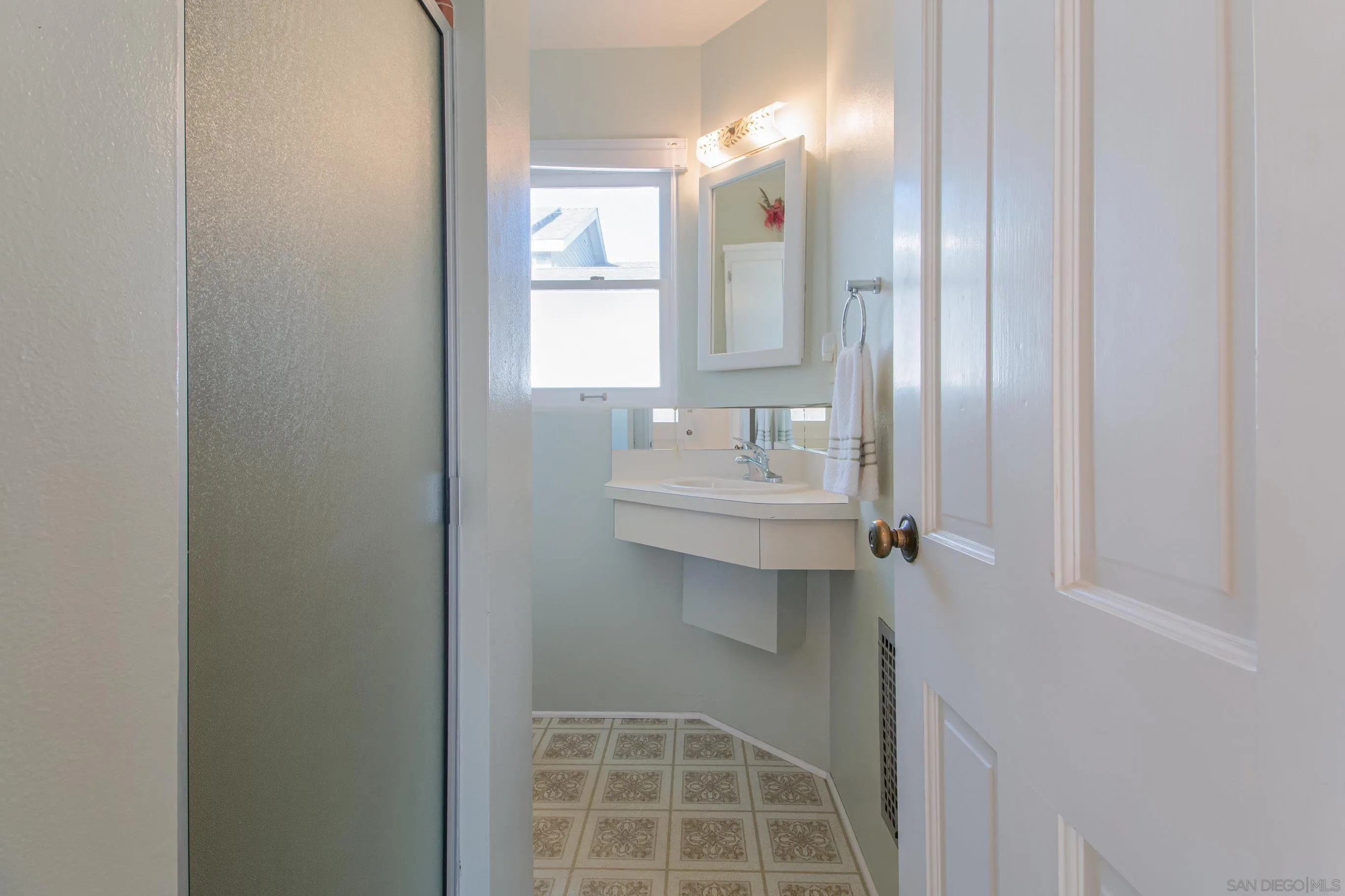 545 J Avenue Coronado, CA 92118 - Photo 11 of 26 a bathroom with a sink a toilet and mirror