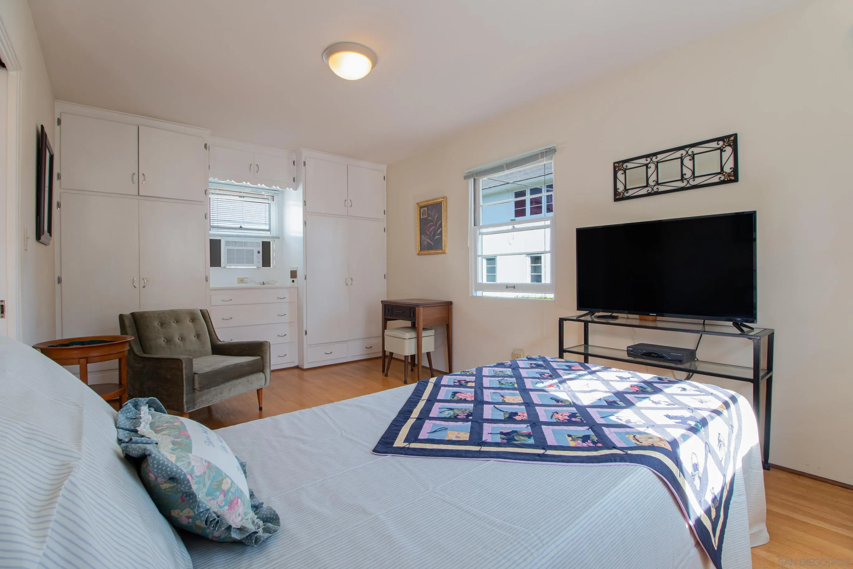 545 J Avenue Coronado, CA 92118 - Photo 13 of 26 a bedroom with a bed and a flat screen tv
