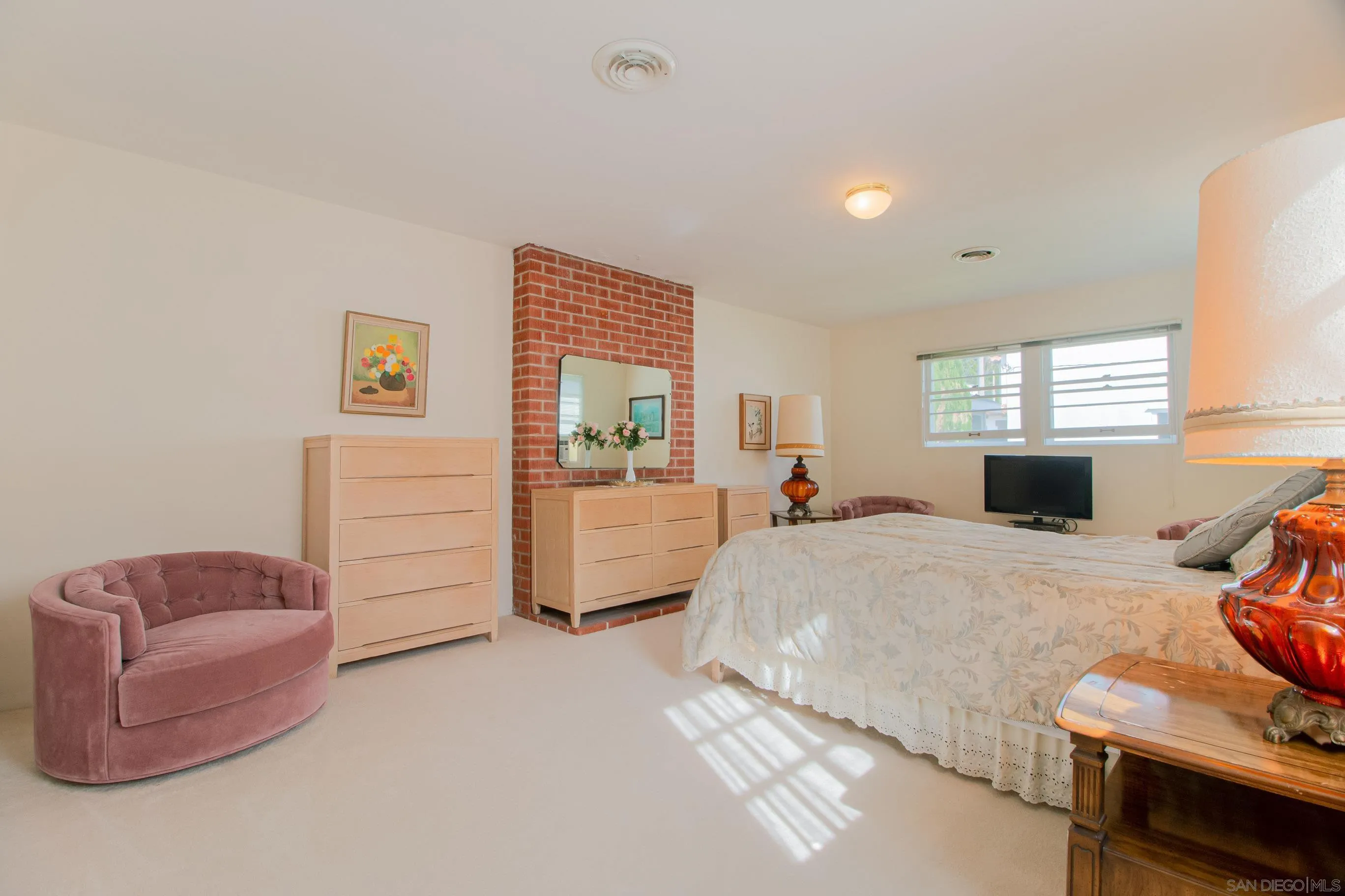 545 J Avenue Coronado, CA 92118 - Photo 18 of 26 a bed room with a bed and a couch