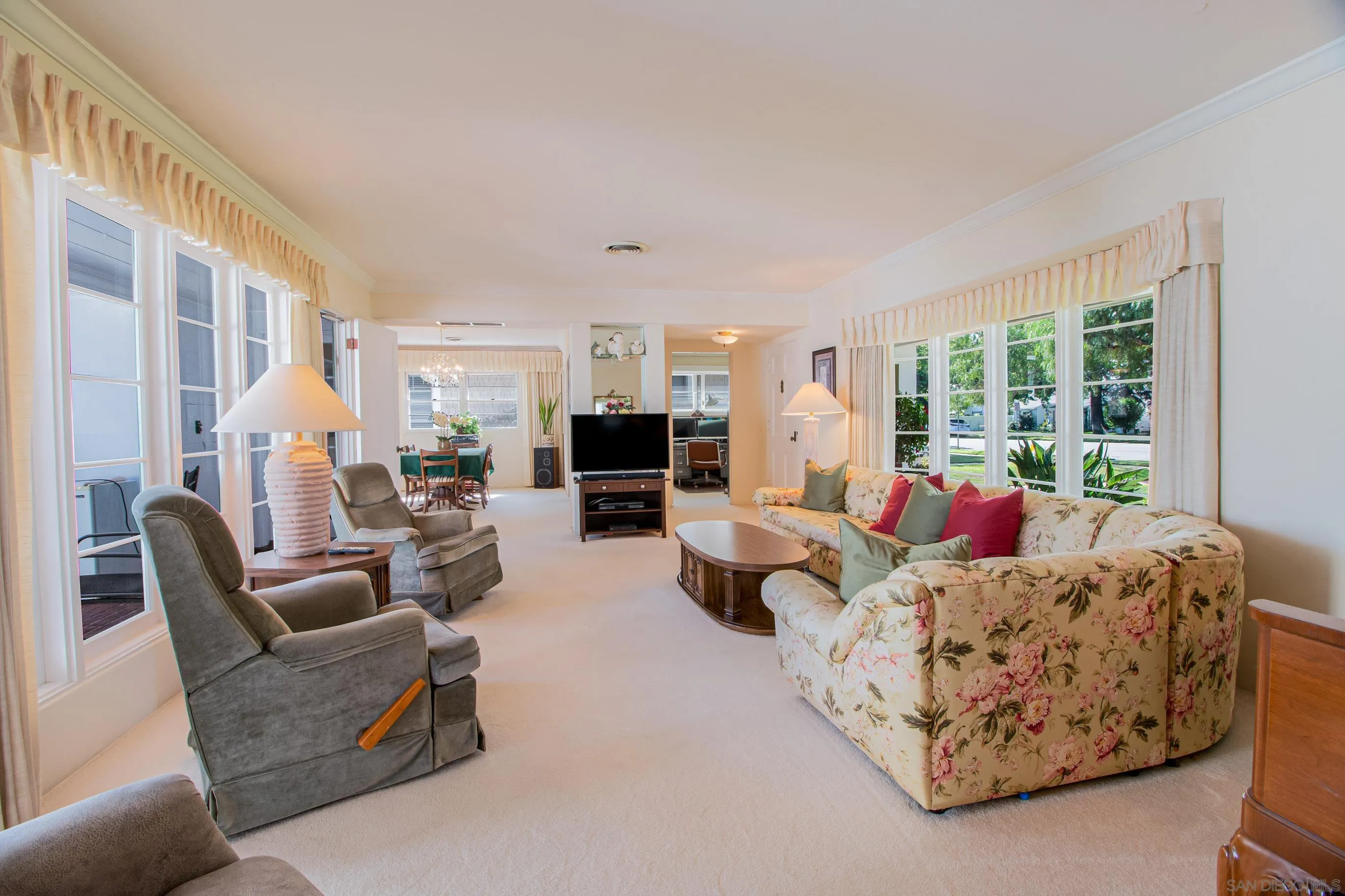 545 J Avenue Coronado, CA 92118 - Photo 5 of 26 a living room with furniture fireplace and large windows