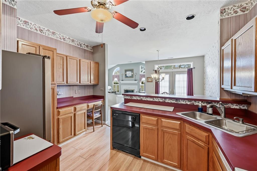 76 Stone Ridge Boulevard Hermitage, PA 16148 - Photo 19 of 34 a kitchen with stainless steel appliances granite countertop a sink and wooden cabinets