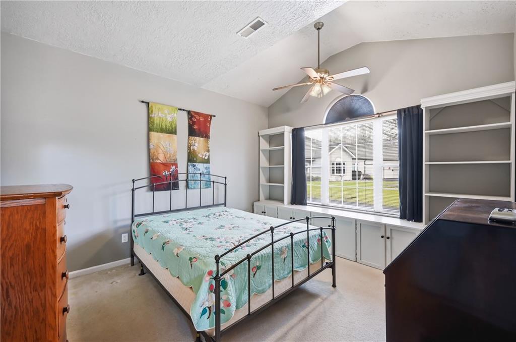 76 Stone Ridge Boulevard Hermitage, PA 16148 - Photo 21 of 34 a bedroom with a bed and a chandelier