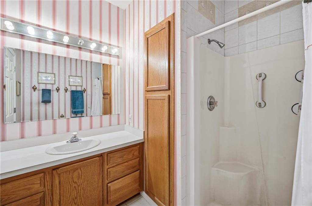 76 Stone Ridge Boulevard Hermitage, PA 16148 - Photo 24 of 34 a bathroom with a shower sink and mirror
