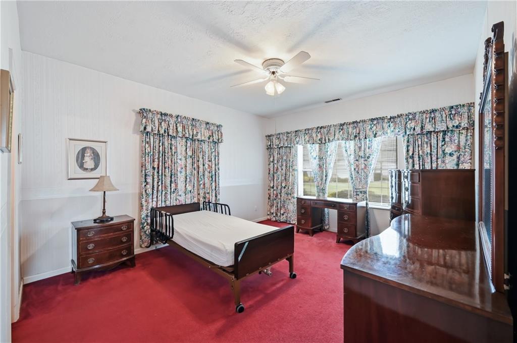 76 Stone Ridge Boulevard Hermitage, PA 16148 - Photo 26 of 34 a bedroom with a bed window and flat screen tv