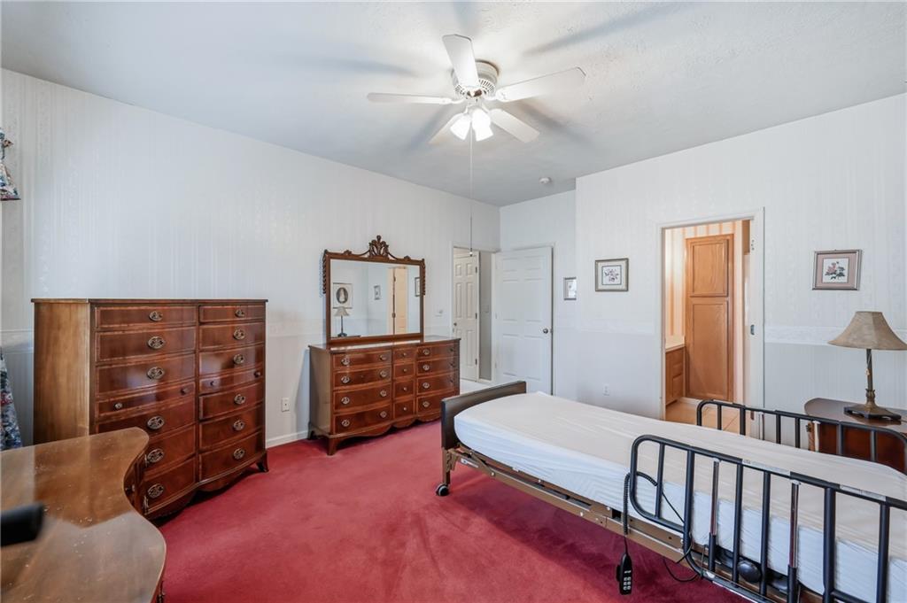 76 Stone Ridge Boulevard Hermitage, PA 16148 - Photo 27 of 34 a bedroom with furniture and a chandelier