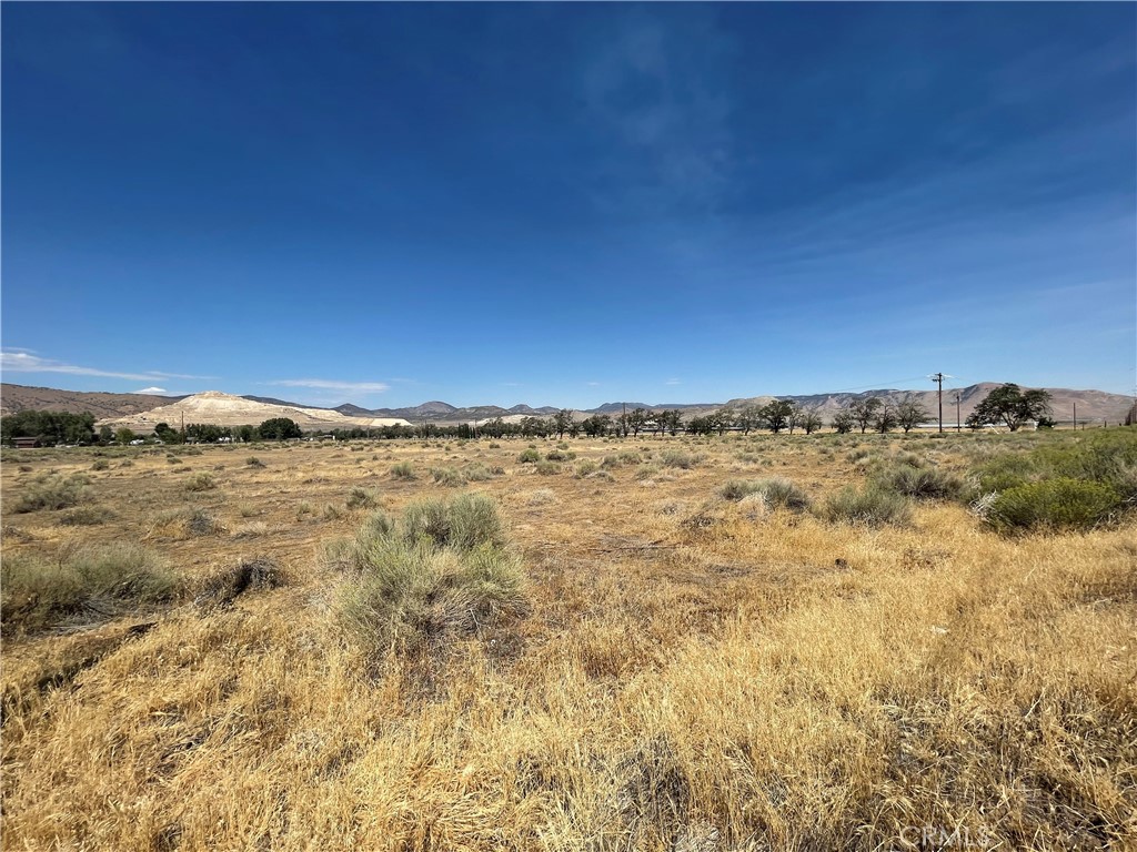 15100 Highline Road Tehachapi, CA 93561 - Photo 3 of 4 a view of a large building with mountains in the background