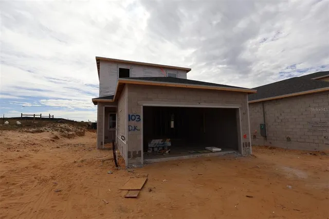 a view of a house with trees in the background