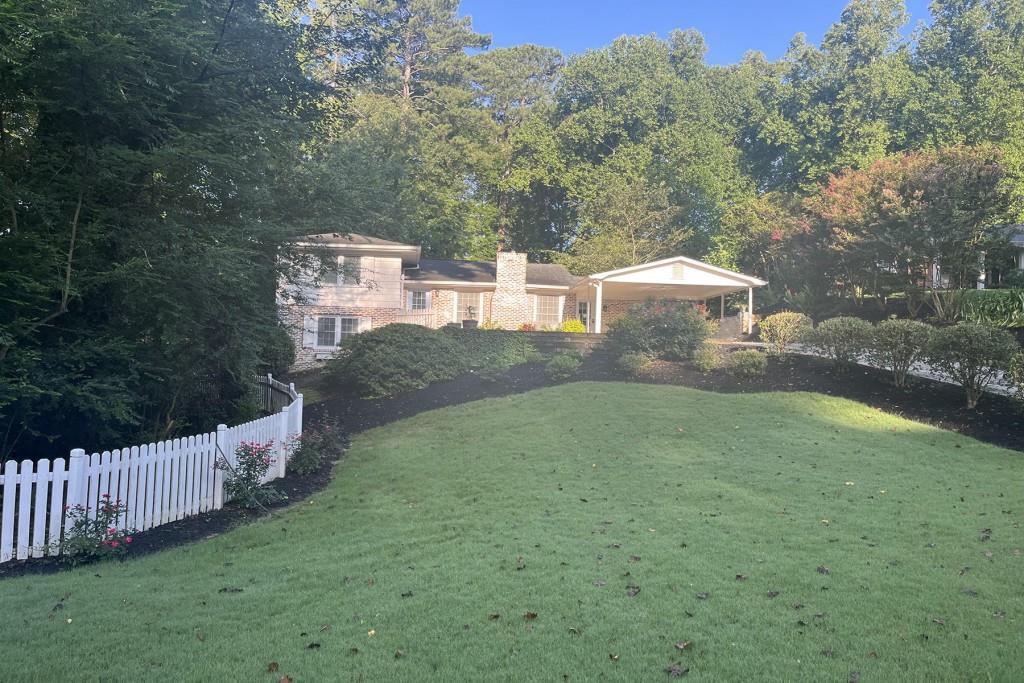 6404 Colebridge Road Northwest Sandy Springs, GA 30328 - Photo 1 of 1 a view of a house with a yard and a large tree