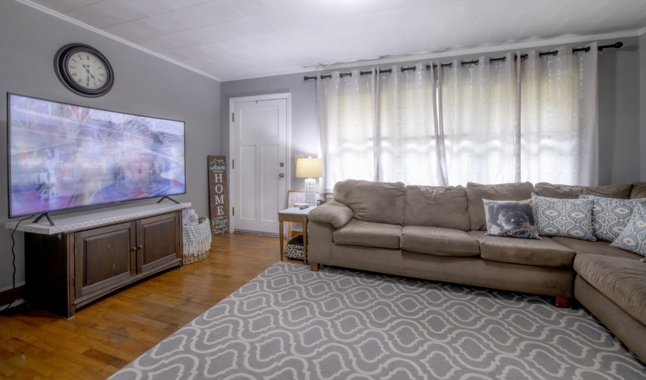 3795 Seven Paths Road Louisburg, NC 27549 - Photo 12 of 21 a living room with furniture a fireplace and a window