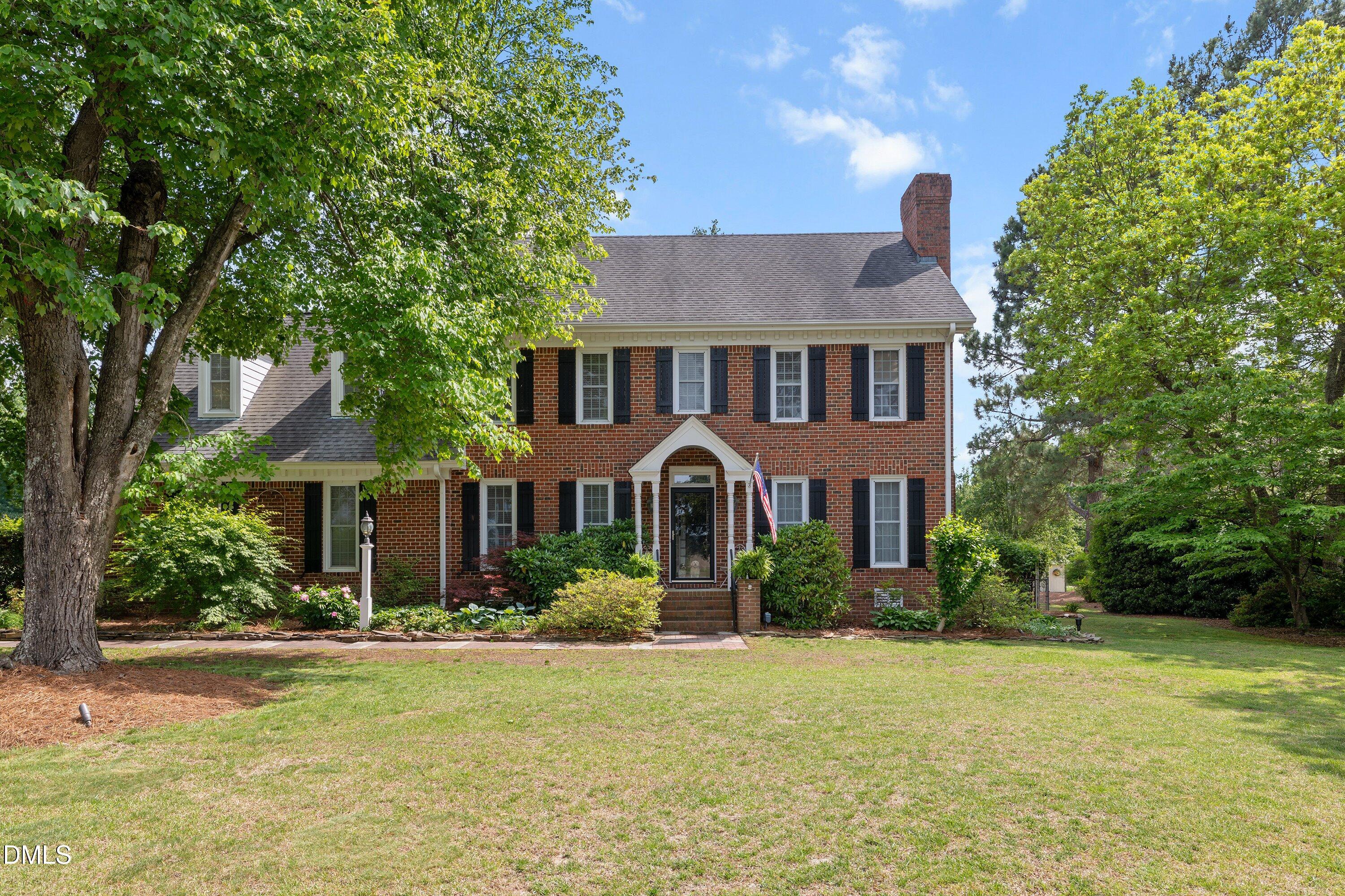 6612 Fowler Road Zebulon, NC 27597 - Photo 1 of 42 a front view of a house with garden