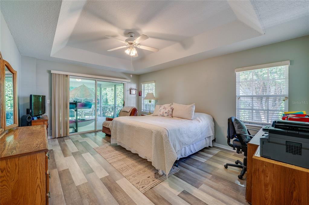 27 Foxhunter Flat Ormond Beach, FL 32174 - Photo 18 of 47 a bedroom with a bed and a chandelier