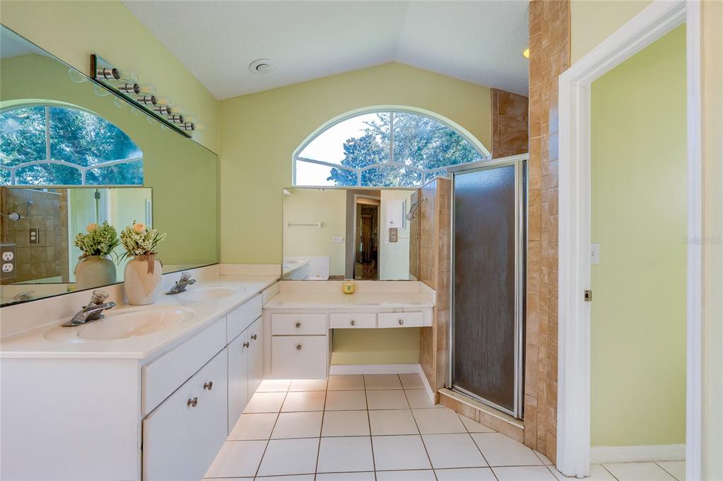 27 Foxhunter Flat Ormond Beach, FL 32174 - Photo 19 of 47 a spacious bathroom with a double vanity sink and a mirror