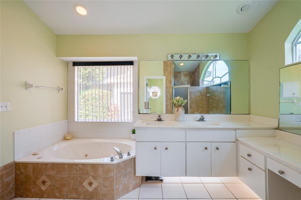 27 Foxhunter Flat Ormond Beach, FL 32174 - Photo 20 of 47 a bathroom with a tub sink and mirror