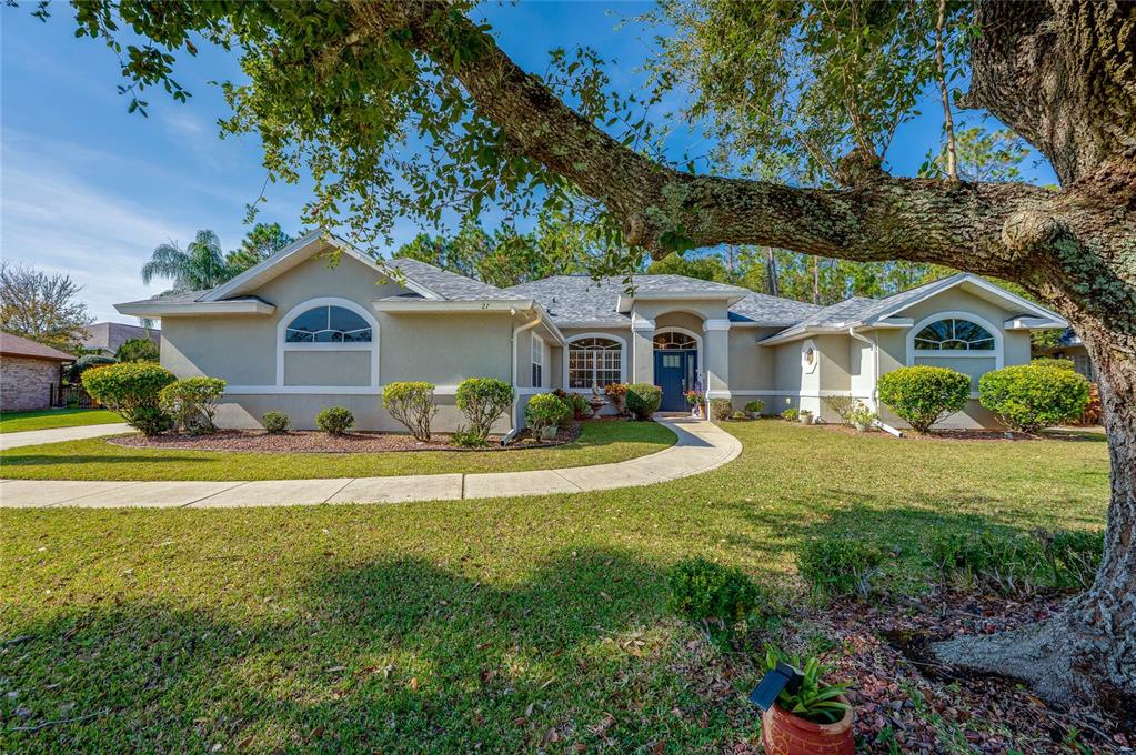 27 Foxhunter Flat Ormond Beach, FL 32174 - Photo 2 of 47 a front view of a house with a garden and porch