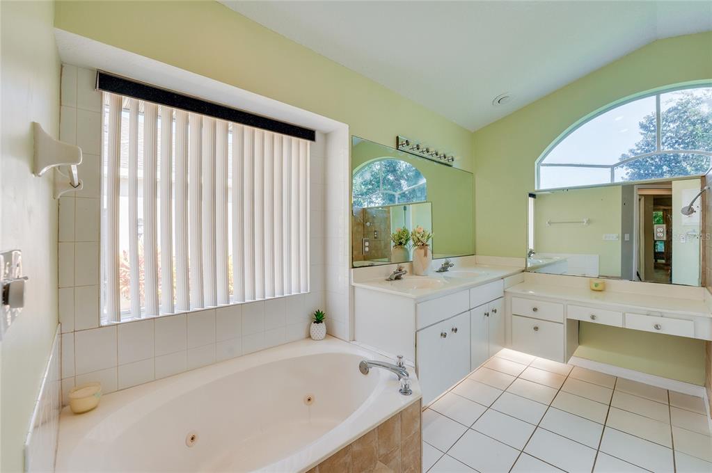 27 Foxhunter Flat Ormond Beach, FL 32174 - Photo 21 of 47 a bathroom with a bathtub sink and mirror