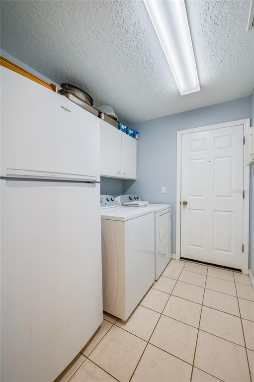 27 Foxhunter Flat Ormond Beach, FL 32174 - Photo 27 of 47 a utility room with cabinets washer and dryer