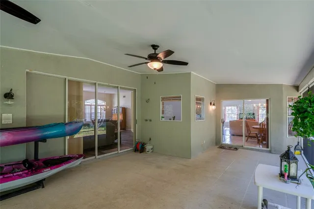 a living room with furniture and a ceiling fan