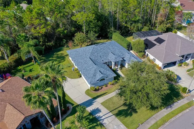 an aerial view of a house with outdoor space