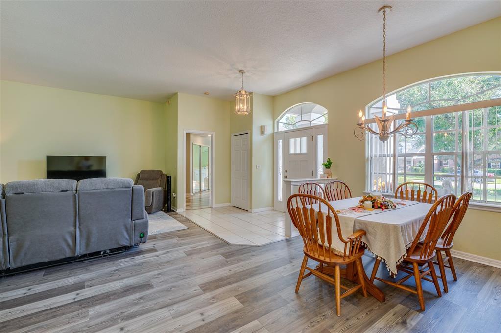 27 Foxhunter Flat Ormond Beach, FL 32174 - Photo 8 of 47 a dining room with furniture a chandelier and wooden floor