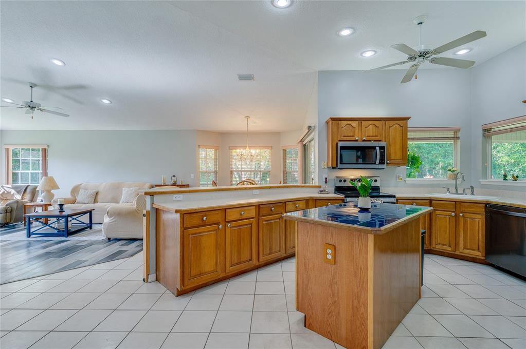 27 Foxhunter Flat Ormond Beach, FL 32174 - Photo 10 of 47 a kitchen with stainless steel appliances granite countertop a sink and cabinets